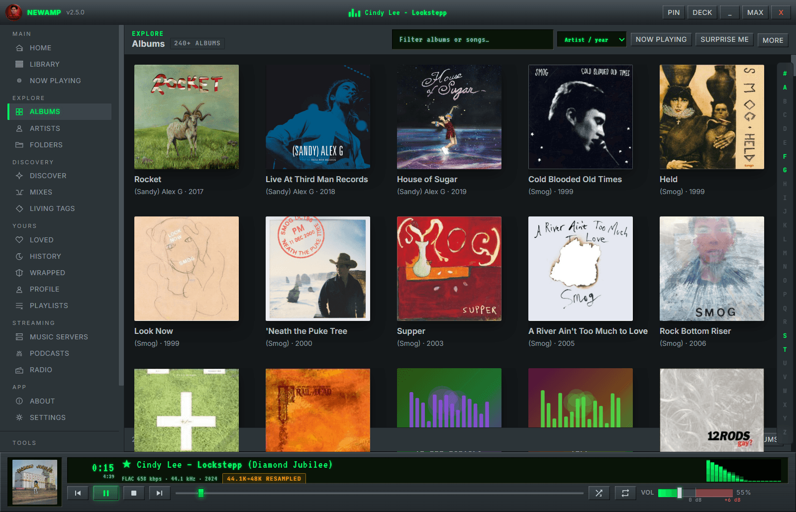 NewAmp's Albums view — a dense grid of real album covers with an alphabet rail, filter box, and Surprise Me button