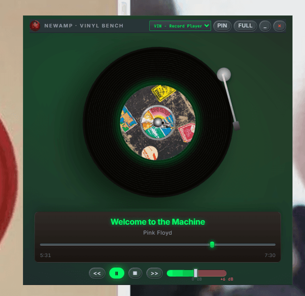 NewAmp's Vinyl Bench deck skin — a record-player-styled compact window with a spinning 45 and weighted tonearm